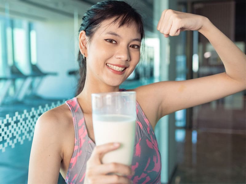 best-protein-powder-women young woman with a glass of protein shake to illustrate best protein powder for women