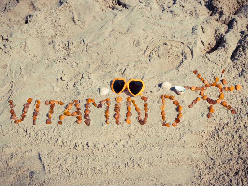 LM-vitamin-D3-injections Pebbles on the sand reading "vitamin D" and a sun shape, to illustrate vitamin D3 injections